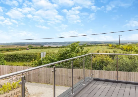 The fa reaching view from the decked balcony, barbecue & alfresco dining area at Rock View, Little Petherick