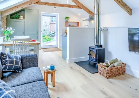 Rolling Hills, Lee is a beautifully renovated one-bedroom character cottage with original oak beams, a crackling wood burner, and a sun-drenched deck with sea views, making it a romantic base for exploring North Devon's stunning coastline.