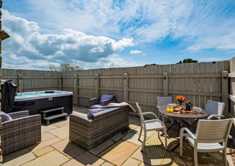 The patio, hot tub, barbecue, alfresco dining & outdoor sitting area at Rose Cottage at Higher Worthyvale Farm, Camelford
