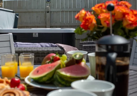 The patio, hot tub, barbecue, alfresco dining & outdoor sitting area at Rose Cottage at Higher Worthyvale Farm, Camelford