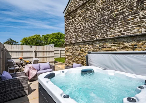 The patio, hot tub, barbecue, alfresco dining & outdoor sitting area at Rose Cottage at Higher Worthyvale Farm, Camelford