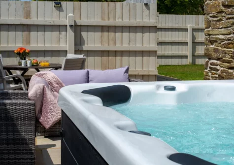 The patio, hot tub, barbecue, alfresco dining & outdoor sitting area at Rose Cottage at Higher Worthyvale Farm, Camelford