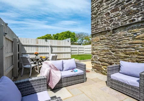 The patio, barbecue, alfresco dining & outdoor sitting area at Rose Cottage at Higher Worthyvale Farm, Camelford
