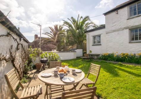 The patio, barbecue, alfresco dining area & enclosed lawned garden at Rose Cottage, Helford