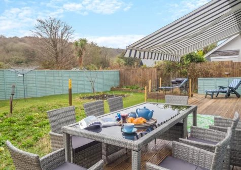 The decked terrace, alfresco dining area & enclosed garden at Rose Retreat, Perranporth