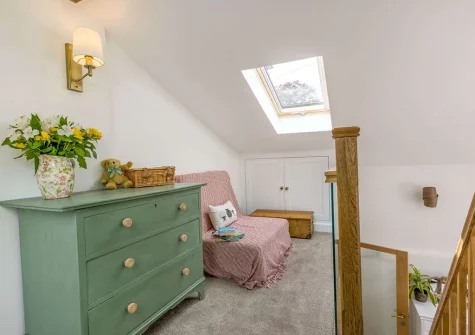 The mezzanine bedroom at Rose Week Cottage, Langtree