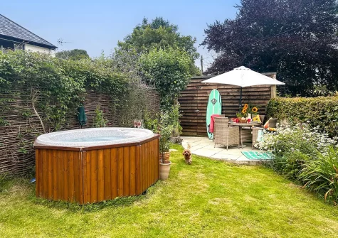The patio, alfresco dining area, hot tub & garden at Rose Week Cottage, Langtree
