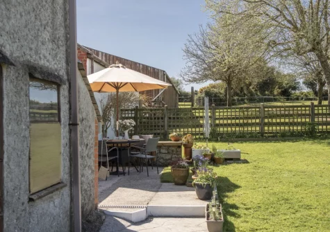 The patio, barbecue, alfresco dining area & enclosed garden at Roseland Cottage, Perranwell Station