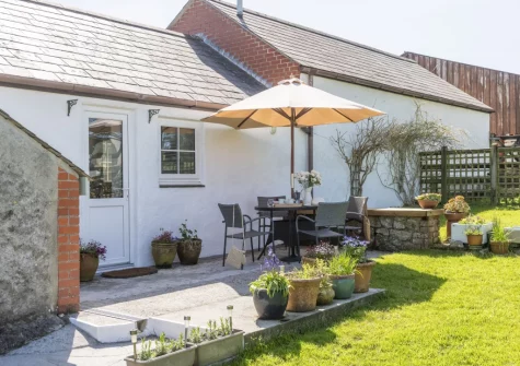 The patio, barbecue, alfresco dining area & enclosed garden at Roseland Cottage, Perranwell Station