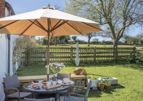 The patio, barbecue, alfresco dining area & enclosed garden at Roseland Cottage, Perranwell Station