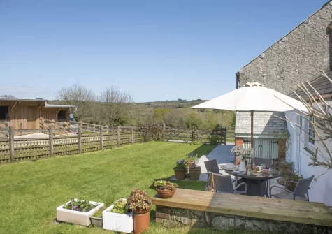 The patio, barbecue, alfresco dining area & enclosed garden at Roseland Cottage, Perranwell Station