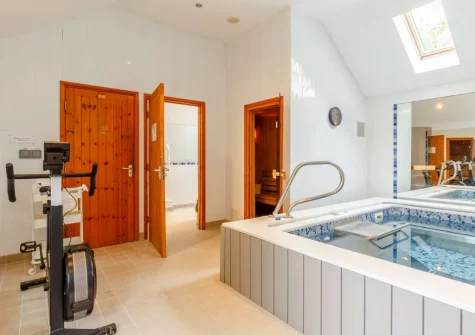 The shared heated indoor endless pool & sauna at South Torfrey Farm, Golant