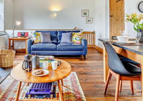 Rowan at South Torfrey Farm, Golant is a characterful two-bedroom barn conversion in the Fowey valley, featuring exposed beams, wood burner warmth, a private hot tub, shared heated pool and sauna, plus the unique on-site Bar Silo for Friday evenings.