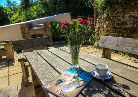 The patio, barbecue & alfresco dining area at Ruby Farm Cottage, Porkellis