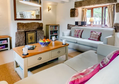 Ruby Farm Cottage, Porkellis is a light-filled three-bedroom retreat in a peaceful hamlet between Falmouth and Porthleven, featuring traditional granite charm, a hidden secret garden, sunny patio with barbecue, and welcoming spaces for families.