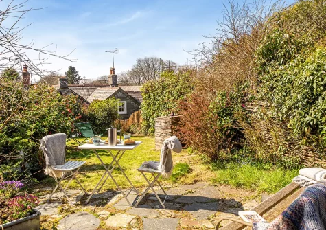 The patio, outdoor sitting area & garden at Ruth's Cottage, St Teath