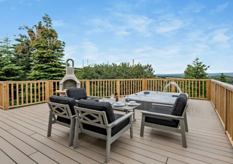 The decked patio, barbecue, outdoor sitting area & hot tub at Salcombe Lodge, Marldon