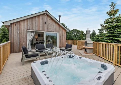The hot tub, decked patio & outdoor sitting area at Salcombe Lodge, Marldon