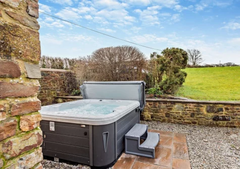The patio & hot tub at Salterns River, Weare Giffard