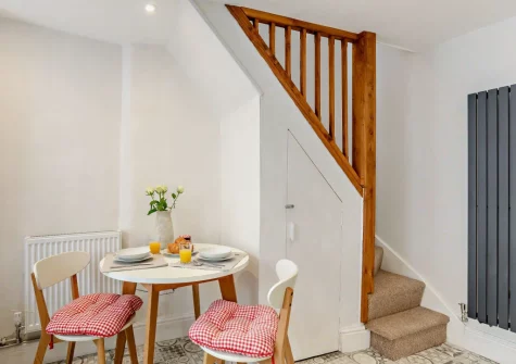 The dining area & stairs up to the first floor at Sanderling Cottage, Looe
