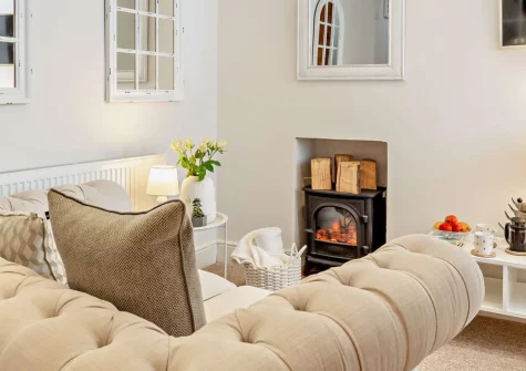 Sanderling Cottage, Looe is a romantic one-bedroom retreat tucked in a traffic-free lane just moments from the harbour and sandy beach, featuring exposed beams, a vaulted ceiling and a cosy feature fire, perfect for an intimate coastal escape.