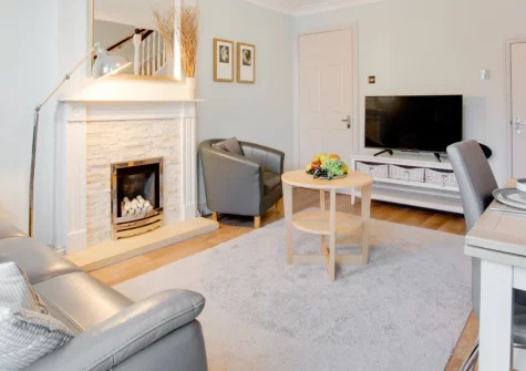 Sands, Padstow is a beautifully presented two-bedroom property nestled within tranquil landscaped grounds in the heart of this celebrated harbour town, featuring a sun-filled conservatory, estuary views from a Juliet balcony, and private parking.