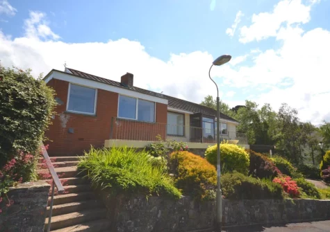 to the front of Sandy Bay Bungalow is a terrace with seating & wonderful views