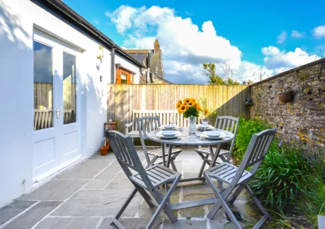 The patio, barbecue & alfresco dining area at School Cottage, Little Petherick