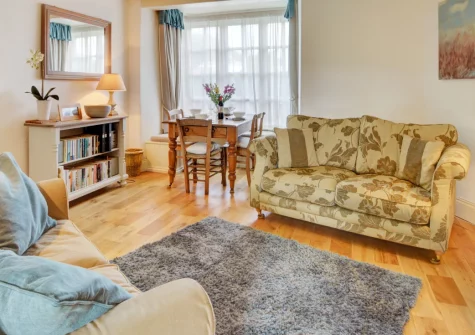 School Cottage, Little Petherick is a characterful two-bedroom retreat fashioned from a former chapel and school, featuring elegant Cornish stone interiors, a cosy wood burner, and peaceful countryside views near Padstow and the Camel Trail.