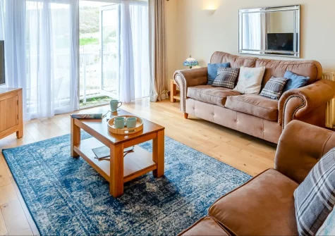 Schooner's, Mortehoe is a bright two-bedroom apartment in a tranquil clifftop village, featuring a balcony with distant sea views, contemporary interiors, and easy access to Woolacombe's golden sands and dramatic North Devon coast paths.