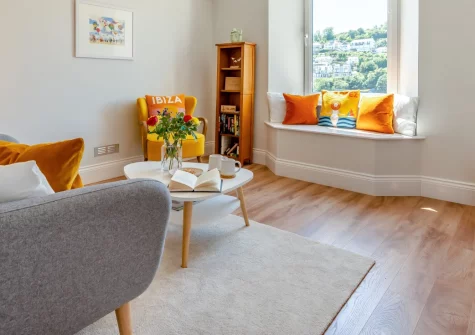 Sea Aster, Looe is a romantic first-floor apartment offering sweeping views across the harbour town to the beach below, a shared bistro terrace for al fresco drinks, and the scenic coast path right on your doorstep for effortless coastal walks.