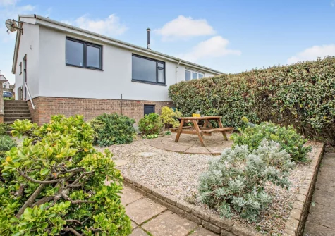The rear garden & alfresco dining area at Sea Escape, Widemouth Bay