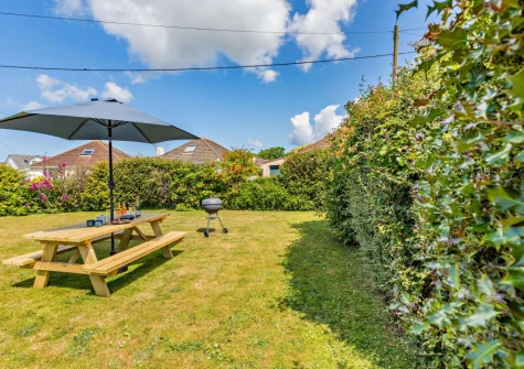 The wraparound lawned garden & alfresco dining area at Sea Mist, Braunton
