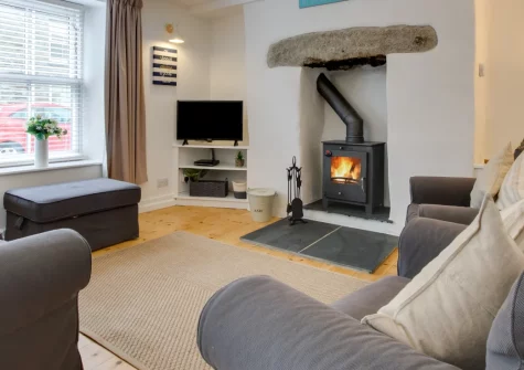 Sea Salt Cottage, Porthleven is a characterful three-storey stone retreat in the heart of this beloved fishing village, featuring a cosy wood burner, colourful coastal interiors, and the historic harbour just three hundred metres from your door.