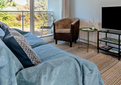 Sea Sparkle, Newquay is a contemporary first-floor apartment moments from Porth Beach, featuring a private balcony with beach views, direct South West Coast Path access, and secure garage storage for surfboards and bikes in Cornwall's surf capital.