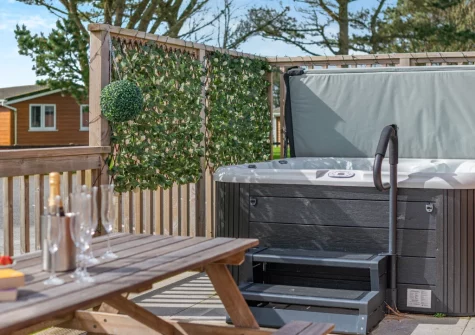 The decked terrace, alfresco dining area & hot tub at Seabreeze Retreat, St Merryn