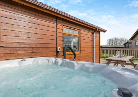 The decked terrace, alfresco dining area & hot tub at Seabreeze Retreat, St Merryn