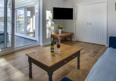 Seacroft, Polruan is a beautifully furnished four-bedroom waterside house with stunning estuary views, a generous outdoor terrace overlooking the harbour, and private boat mooring in the heart of this enchanting Cornish fishing village.