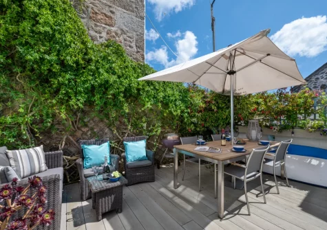 The decked courtyard garden & alfresco dining area at Seahorse Cottage, Mousehole