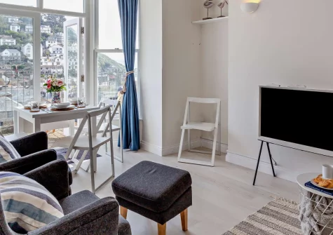 Seascape, Looe is a beautifully presented two-bedroom apartment with elevated views across East Looe River and the sea, featuring a private sun-drenched terrace, contemporary interiors, and the South West Coast Path virtually on the doorstep.