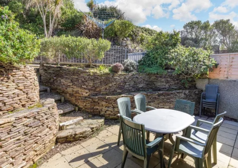 The patio, alfresco dining area & tiered garden at Seascape, Porthleven