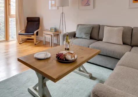 Seaspray, Porthleven is a bright first-floor apartment set in a tranquil courtyard near the harbour, featuring a sunny private balcony, stylish coastal interiors, and easy access to the South West Coast Path and West Cornwall's stunning beaches.