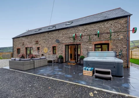 The patio, outdoor sitting area & hot tub at Shearing Shed, Combe Martin