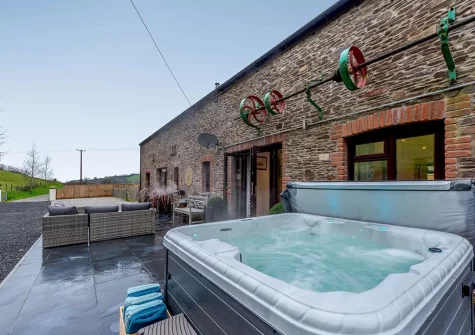 The hotub, patio & outdoor sitting area at Shearing Shed, Combe Martin