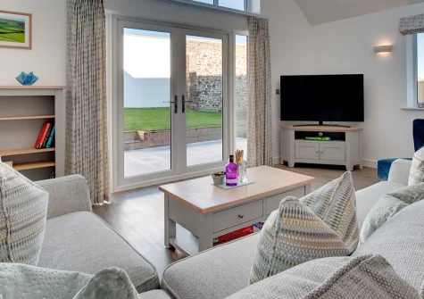 Silver Birches, Westward Ho! is a modern 3-bedroom house with bright, spacious interiors and a unique garage games room. Enjoy the enclosed garden, prime coastal location, and easy access to beaches and attractions, perfect for families.