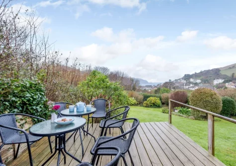 The decked patio, alfresco dining area & garden at Silver Seas, Combe Martin