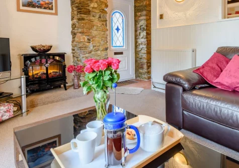 Skippers Cottage, Ilfracombe is a characterful two-bedroom harbourside retreat positioned directly on the historic quay, offering sea views, coastal charm, and the beach, shops, and restaurants of this vibrant seaside town just steps from your door.
