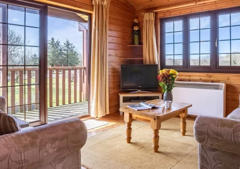 Sky Lark Lodge 7 at Clovelly Lakes, Higher Clovelly is a tranquil three-bedroom lakeside retreat set within 320 acres of Devon countryside, featuring a wraparound balcony with lake views, complimentary fishing, and woodland walks on your doorstep.