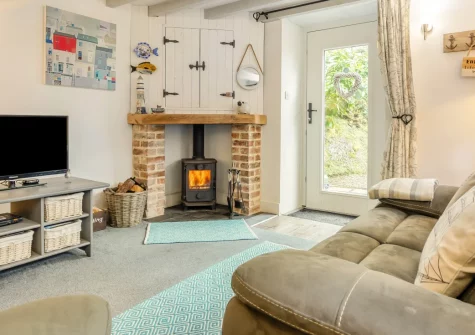 Skyber Riverview Barn, Tresarrett is a beautifully restored 300-year-old barn conversion in the heart of Bodmin Moor, featuring riverside garden views, direct Camel Trail access, and luxurious country interiors with wood burner and roll-top bath.