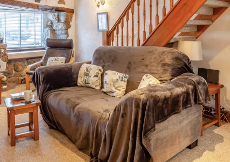 Slipway Cottage, 8 Back Lane, St Ives is a charming two-bedroom retreat in a peaceful pedestrian lane off the wharf, featuring original stone walls, cosy coal-effect fire, and the town's galleries, restaurants, and beaches on your doorstep.